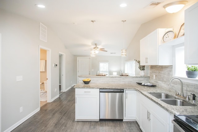 kitchen with white cabinetry, sink, kitchen peninsula, vaulted ceiling, and appliances with stainless steel finishes