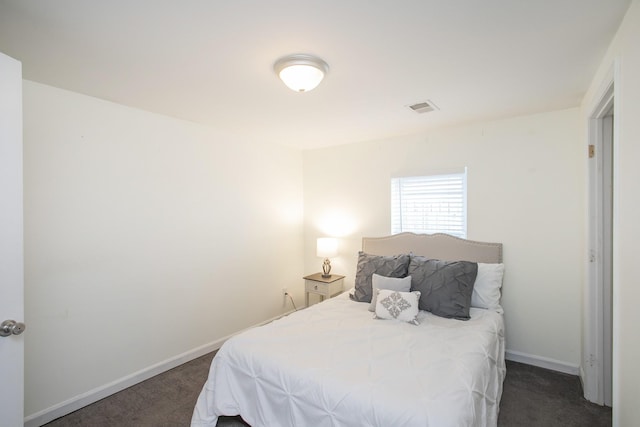 bedroom with dark colored carpet