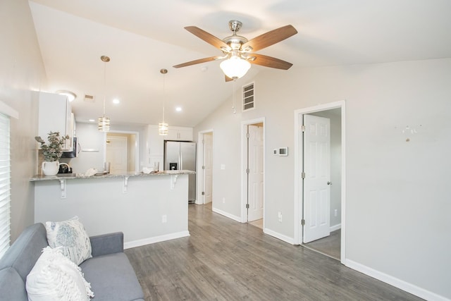 living room with dark wood-type flooring, ceiling fan, and lofted ceiling