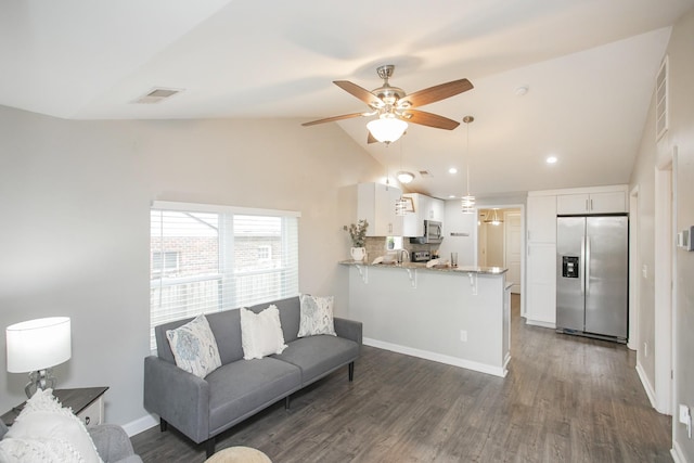 living room with dark hardwood / wood-style floors, vaulted ceiling, and ceiling fan