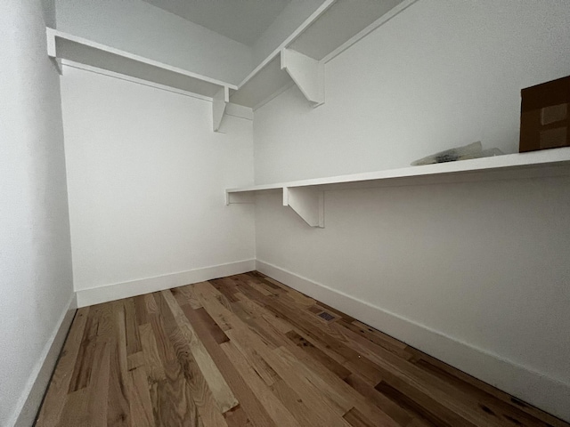 walk in closet with hardwood / wood-style floors