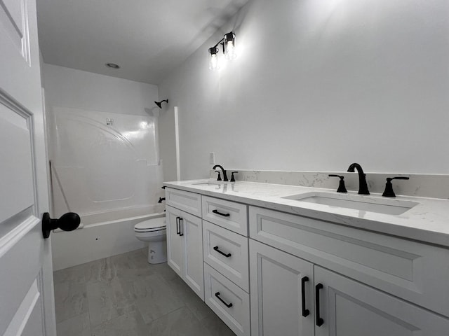 full bathroom featuring washtub / shower combination, vanity, and toilet