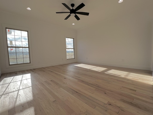 unfurnished room featuring ceiling fan, a healthy amount of sunlight, and light hardwood / wood-style floors