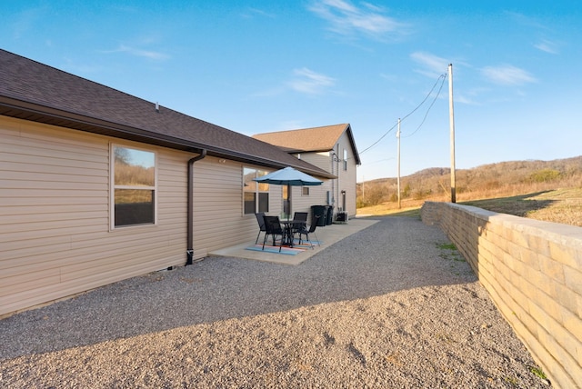 view of property exterior with a patio area