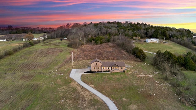 aerial view at dusk featuring a rural view