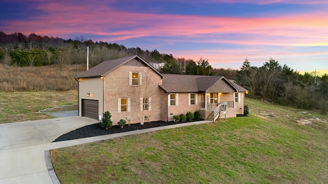 view of front facade featuring a lawn and a garage