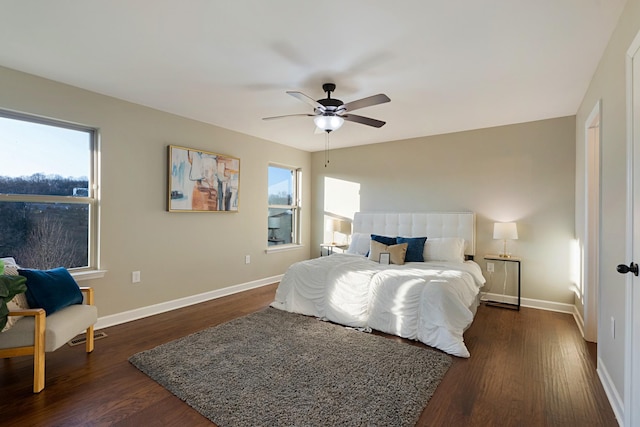 bedroom with multiple windows, ceiling fan, and dark hardwood / wood-style floors