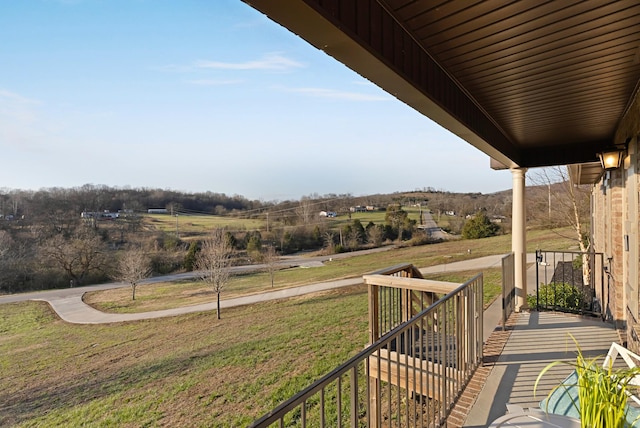 balcony with covered porch and a rural view