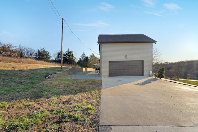 view of property exterior featuring a yard and a garage