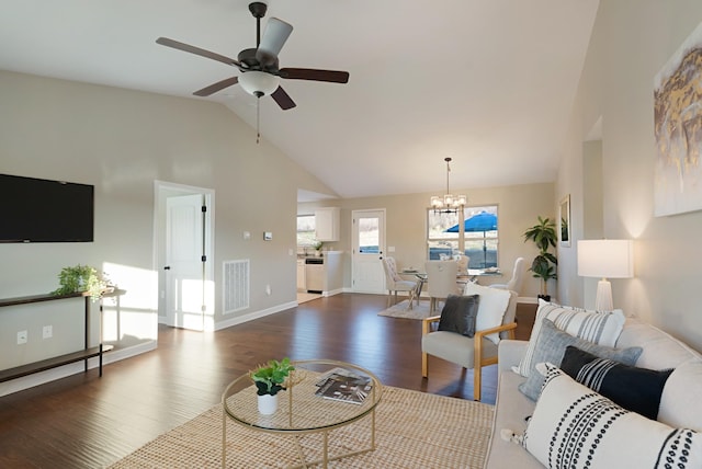 living room featuring ceiling fan with notable chandelier, dark hardwood / wood-style floors, and lofted ceiling