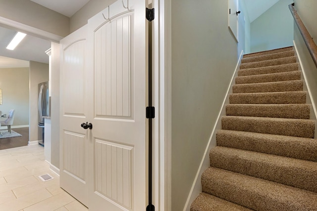 staircase with tile patterned flooring