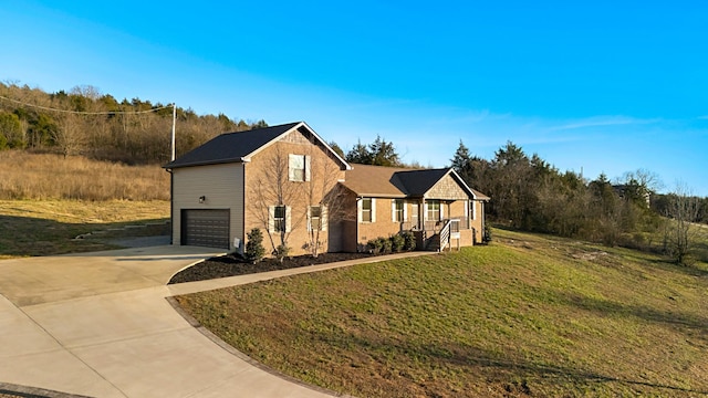 view of front of home with a garage and a front lawn