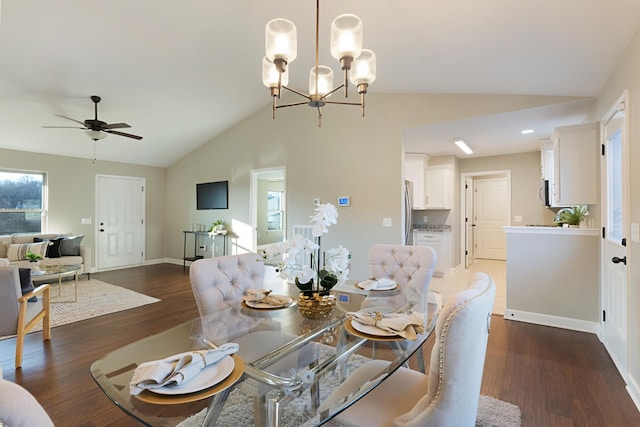 dining room featuring ceiling fan with notable chandelier, dark hardwood / wood-style flooring, and lofted ceiling