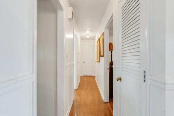 corridor with light wood-type flooring