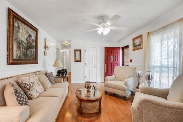 living room featuring hardwood / wood-style floors and ceiling fan