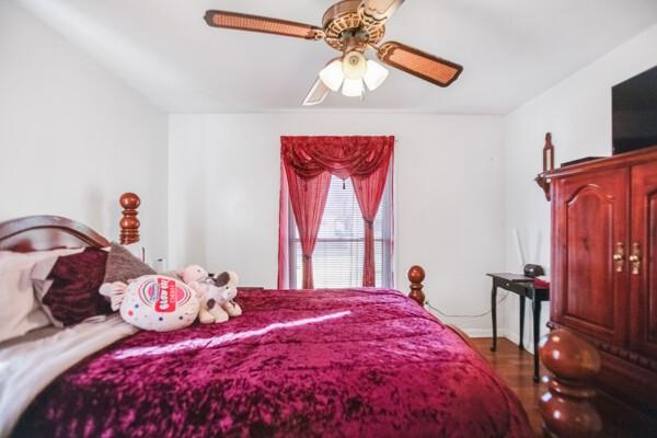 bedroom featuring wood-type flooring and ceiling fan