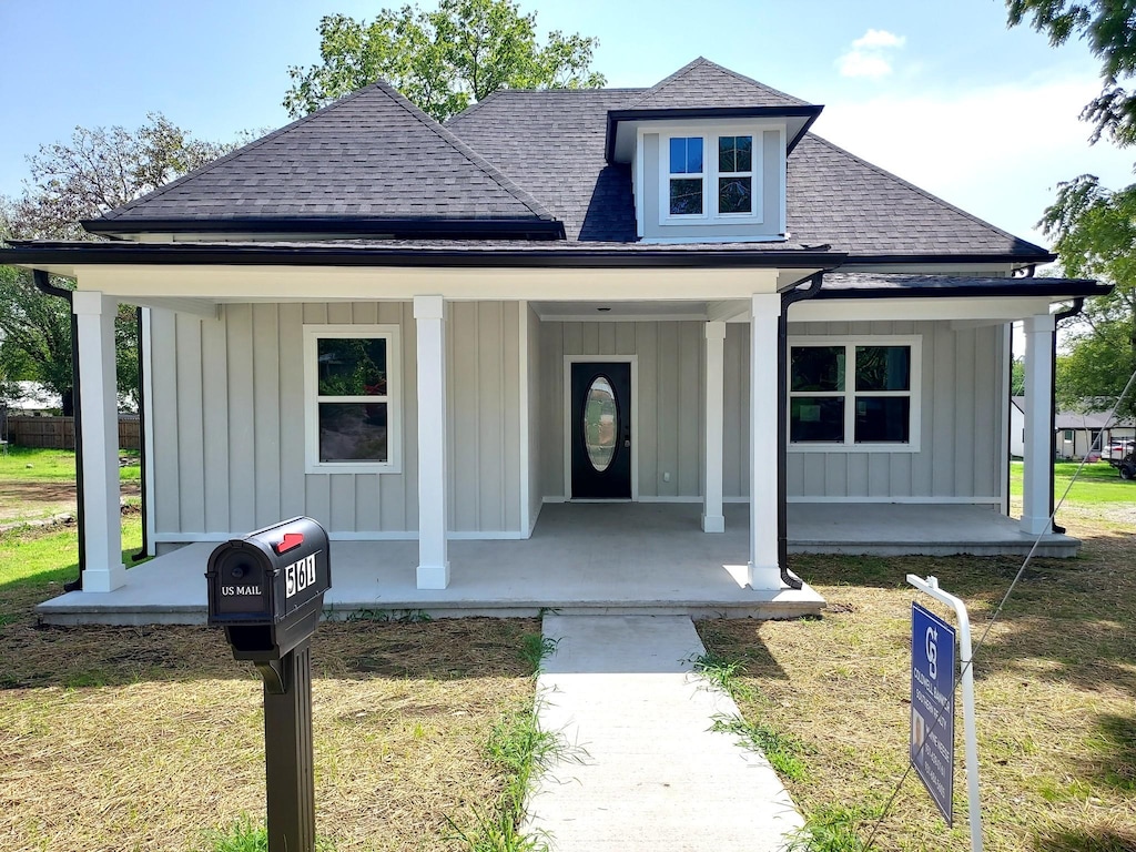 view of front of house with a front lawn and a porch