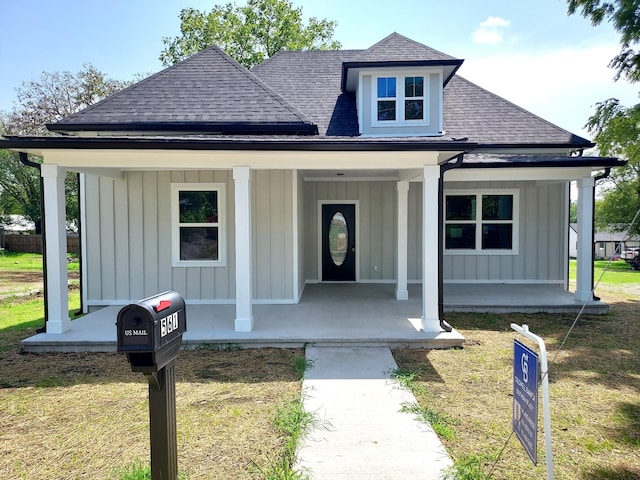 view of front of house with a front lawn and a porch