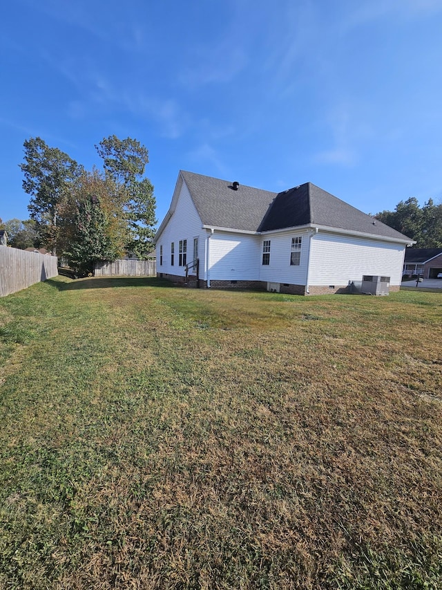 back of property featuring a lawn