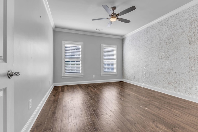 spare room with ceiling fan, crown molding, and dark wood-type flooring