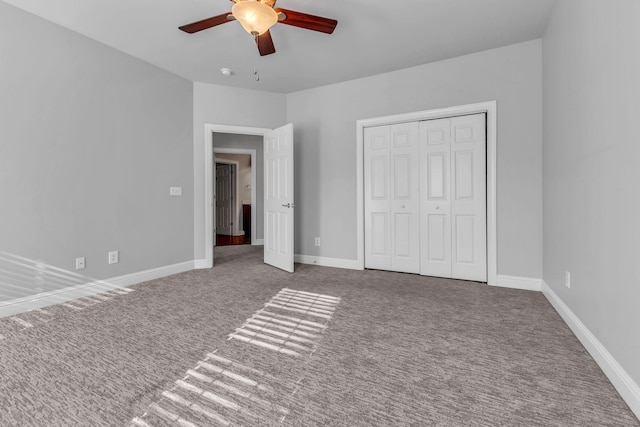 unfurnished bedroom featuring carpet flooring, ceiling fan, and a closet