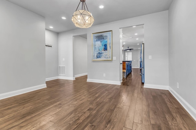 unfurnished dining area featuring ceiling fan and dark hardwood / wood-style floors