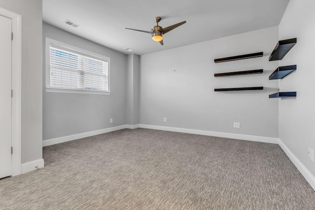 carpeted spare room with ceiling fan