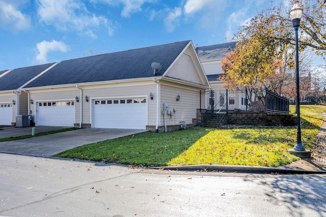 view of front of property with central air condition unit and a front yard