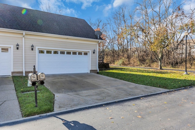 view of side of property featuring a garage and a yard