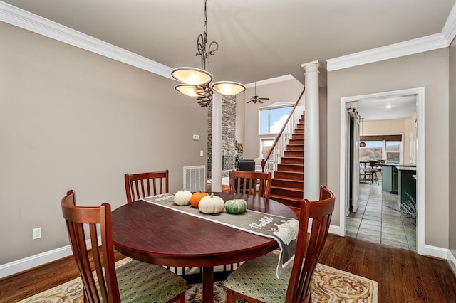 dining area with hardwood / wood-style floors, ornate columns, ceiling fan, and ornamental molding