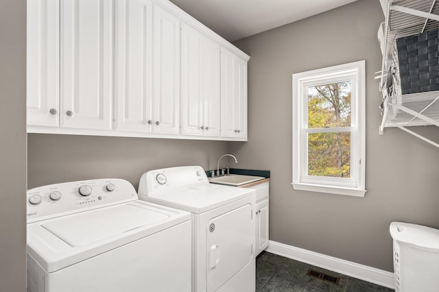 laundry room featuring a healthy amount of sunlight, sink, cabinets, and independent washer and dryer