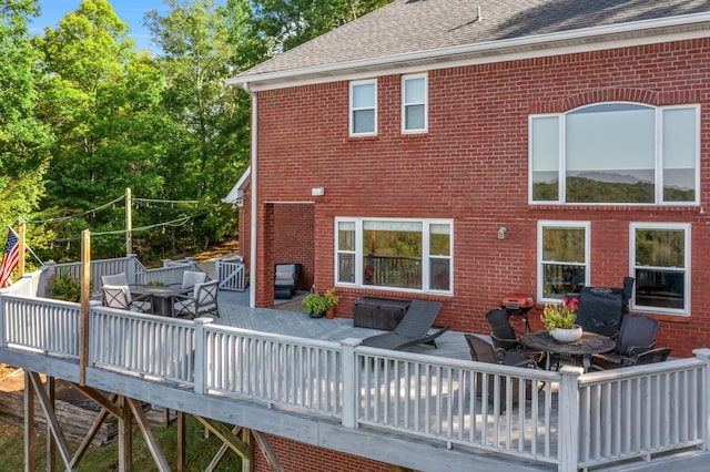 rear view of house with a wooden deck