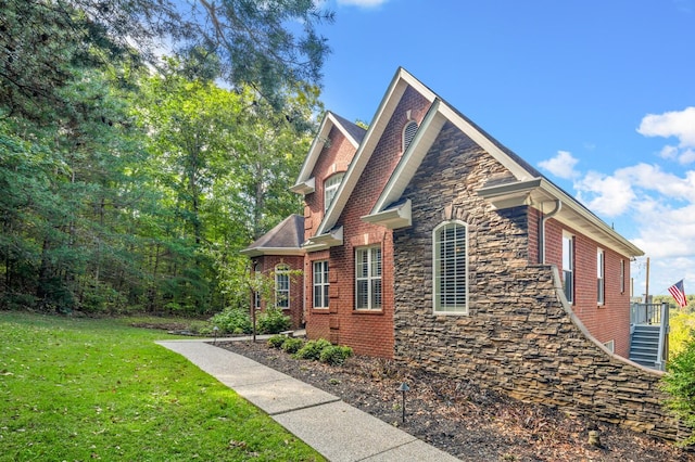 view of side of property with a lawn