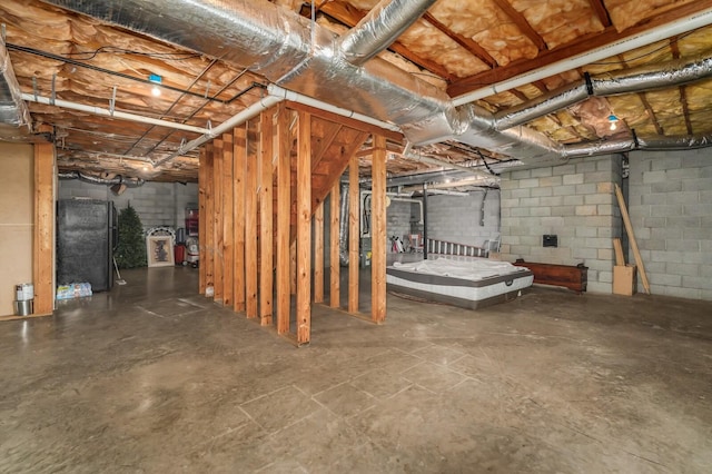 basement featuring black refrigerator