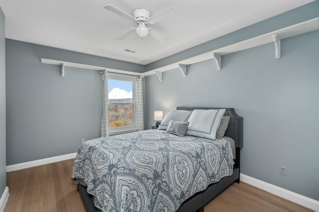 bedroom with ceiling fan and hardwood / wood-style floors