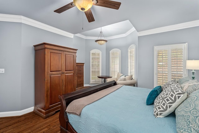 bedroom featuring dark hardwood / wood-style flooring, ceiling fan, and ornamental molding