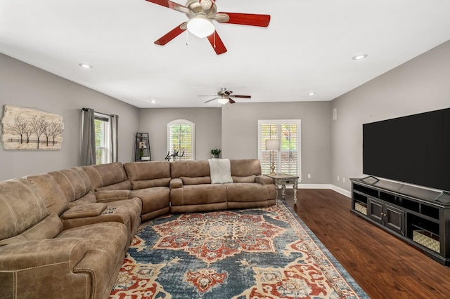 living room with ceiling fan and dark hardwood / wood-style floors