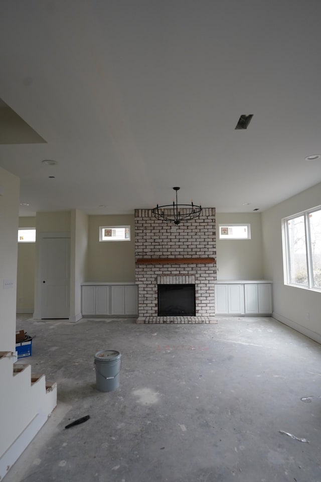 unfurnished living room featuring a brick fireplace