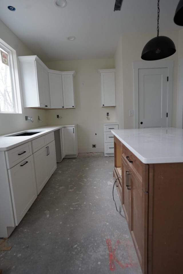 kitchen featuring white cabinetry and sink