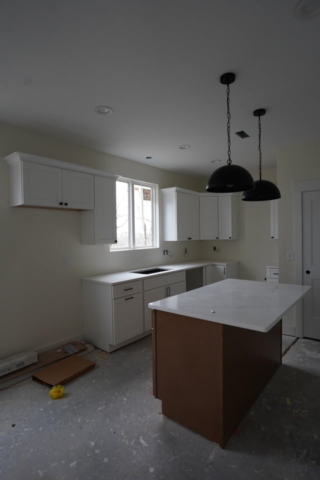 kitchen with pendant lighting, white cabinets, and a kitchen island