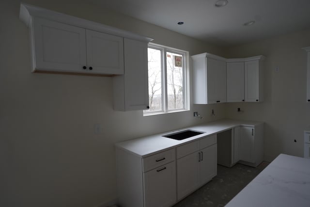 kitchen with white cabinetry and sink