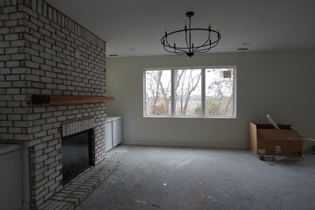 unfurnished living room with an inviting chandelier and a fireplace