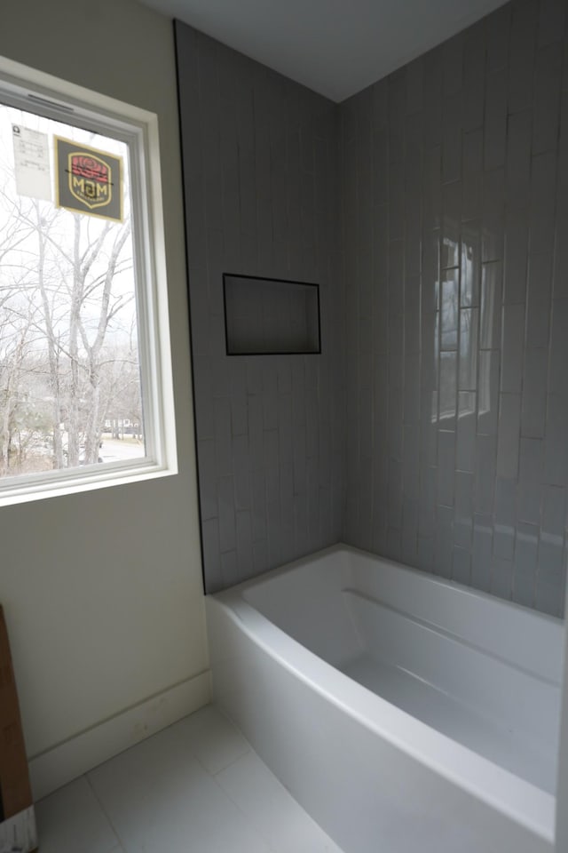 bathroom with tile patterned flooring and a bathtub