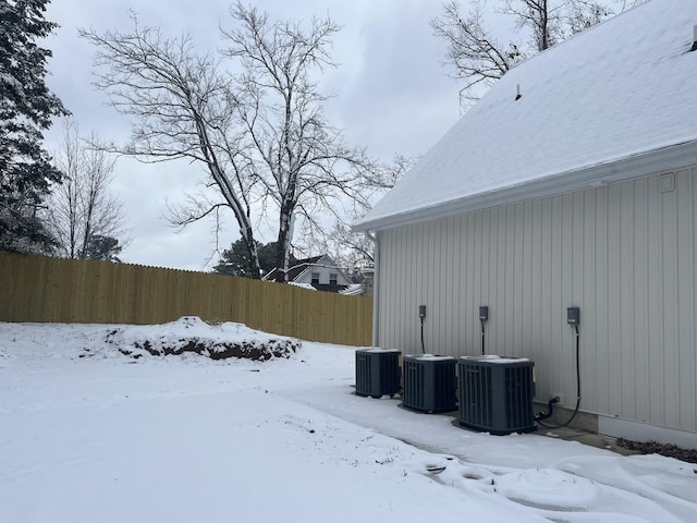 view of snow covered exterior featuring cooling unit