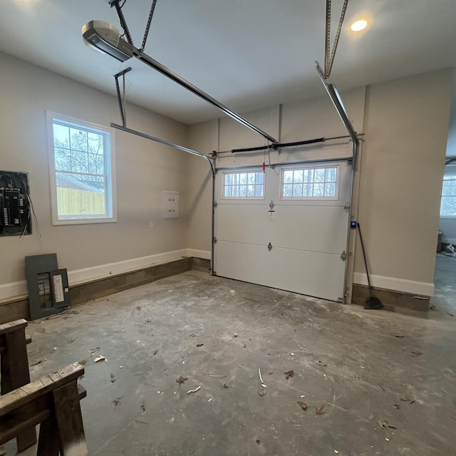 garage featuring electric panel and a garage door opener