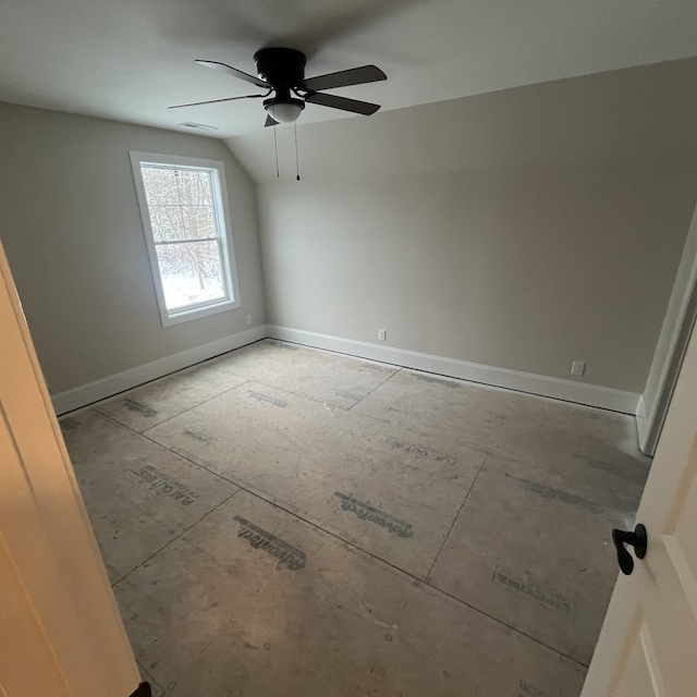 spare room with ceiling fan and vaulted ceiling