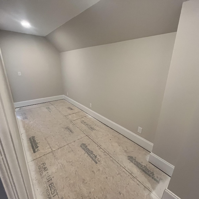 additional living space featuring vaulted ceiling