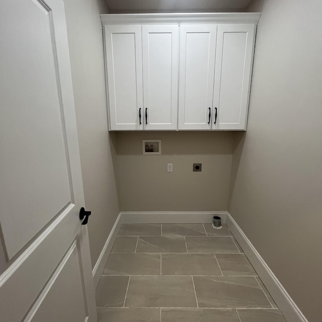 washroom with cabinets, tile patterned flooring, hookup for a washing machine, and electric dryer hookup