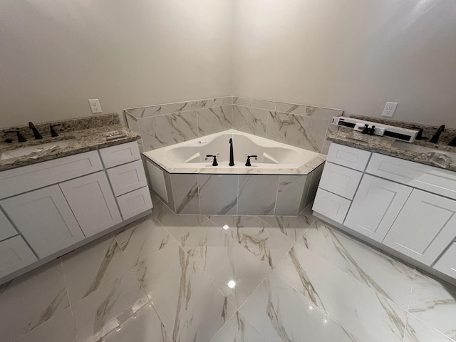 bathroom with tiled tub and vanity