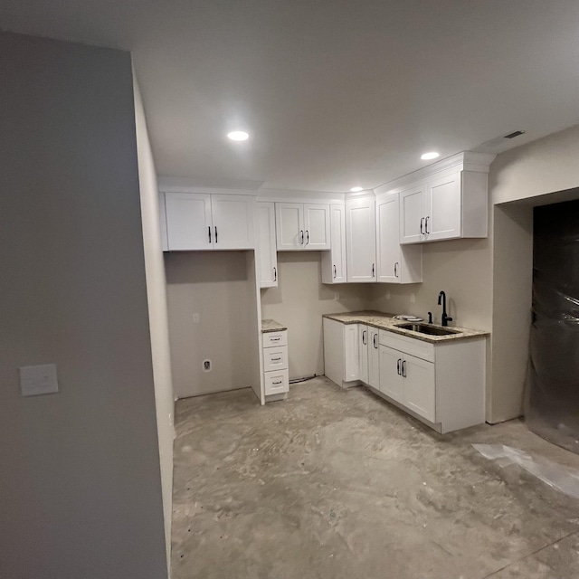 kitchen featuring sink and white cabinetry